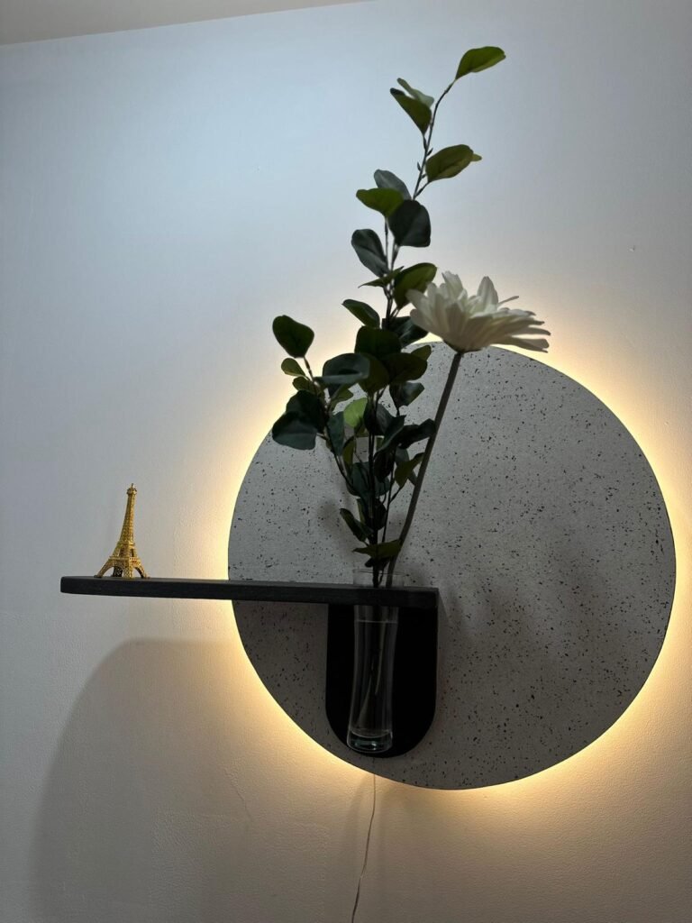 estante circular iluminado con florero y mini torre eiffel
